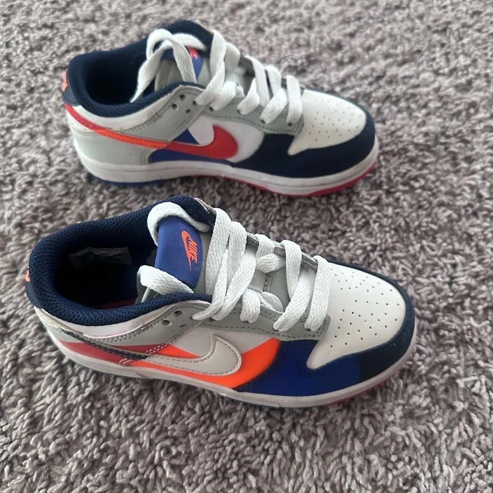 Preloved Nike Kids Navy and White Sneakers with Orange Accents